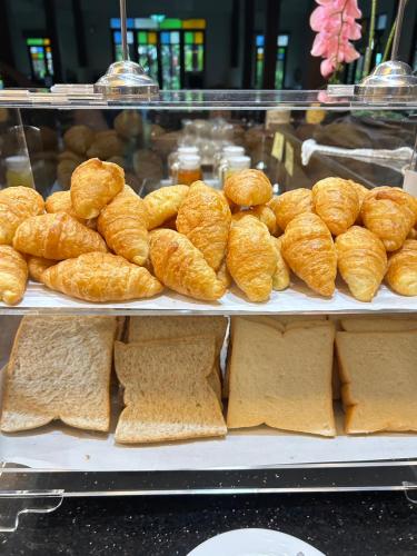 a display of bread and croissants in a bakery at Smile Lanna Hotel in Chiang Mai