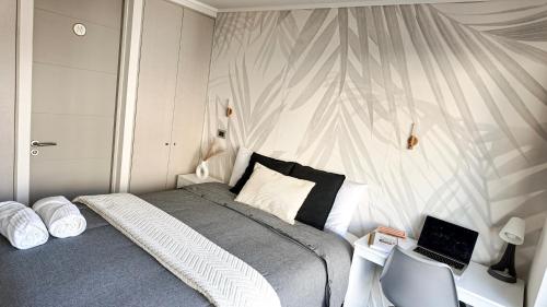 a bedroom with a bed with a laptop on it at exclusive apartment with AC and parking in Santiago