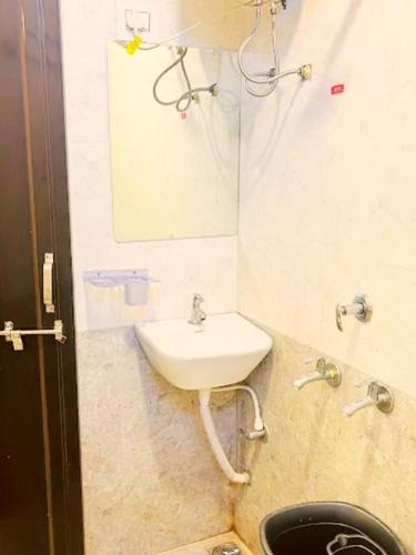 a bathroom with a sink and a mirror at Ritngen Home Stay in Mylliem