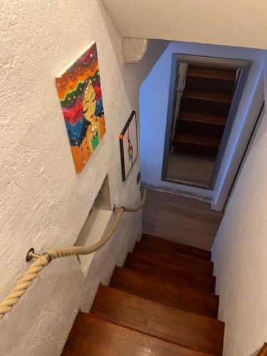 a staircase with a painting on the wall next to a window at Apartment Nikolina in Trogir