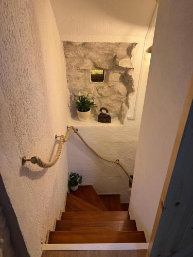 a staircase in a house with a stone wall at Apartment Nikolina in Trogir