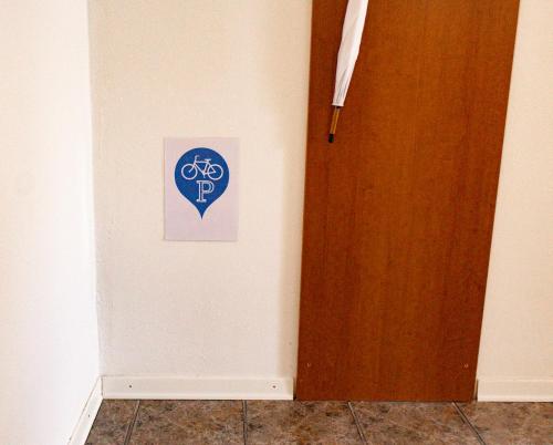a room with a door and a sign on the wall at Apartma Frigidum in Vipava