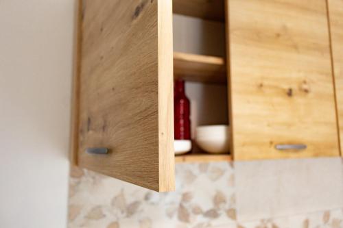 a wooden cabinet with a cupboardigunigunigunigunigunigunigunigunigun at Apartma Frigidum in Vipava