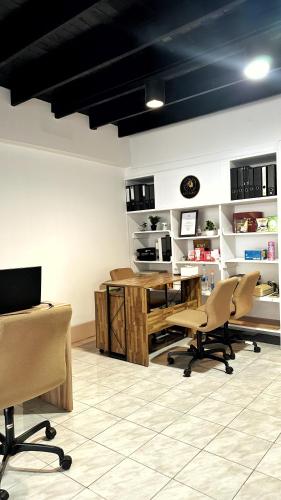 a room with chairs and a desk and a computer at ESSENCE Home in Bangkok