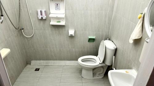 a small bathroom with a toilet and a sink at ESSENCE Home in Bangkok