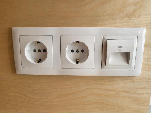 an electrical outlet with three lights on a table at StudentVille Palmeiras in Lisbon