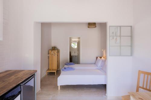 a bedroom with a bed in a white room at Albatross Apartments in Kassiopi