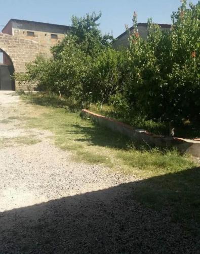 a garden with bushes and a building in the background at Vacation Home in Ashtarak in Ashtarak