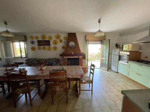 a kitchen and dining room with a table and chairs at Secret Garden of Tossignano in Tossignano