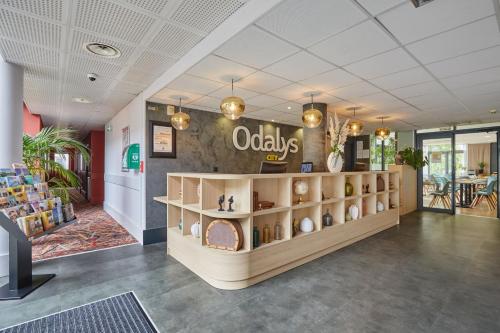 a lobby of a store with a shelf of oodleys at Appart'hôtel Odalys City - Bioparc Lyon Est in Lyon