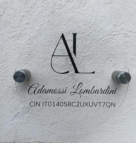 a logo for an advanced learning institution on a white wall at Casa Adamossi Lombardini in Alpe di Bondeno