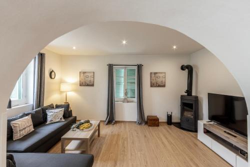 a living room with a couch and a tv at Galata Watermill Cottage in Nicosia