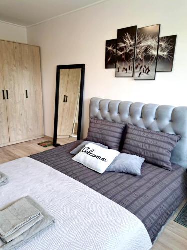a bedroom with a large bed with a pillow on it at Ąžuolų giraitėje 2 bedroom apartments in Klaipėda