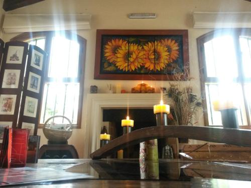 a living room with a fireplace and a painting on the wall at Pilgrim's Rest - Descanso del Peregrino in Chacras de Coria