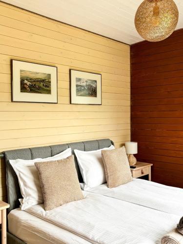a bedroom with two beds with pillows on it at Elysian Fields - Amber Tiny House in Sadu