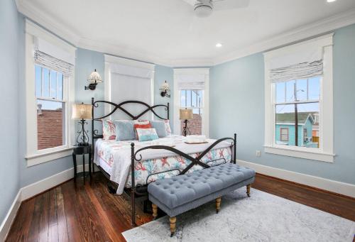 a bedroom with a bed and a bench in it at Blue Gumbo Gorgeous and Located a Few Minutes Walk to Beach in Galveston