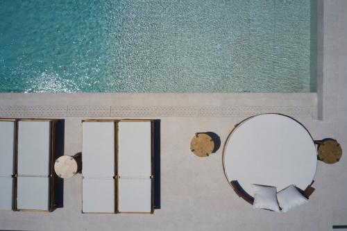 a mirror on a wall in a bathroom at Iria Blue Mykonos in Platis Yialos Mykonos