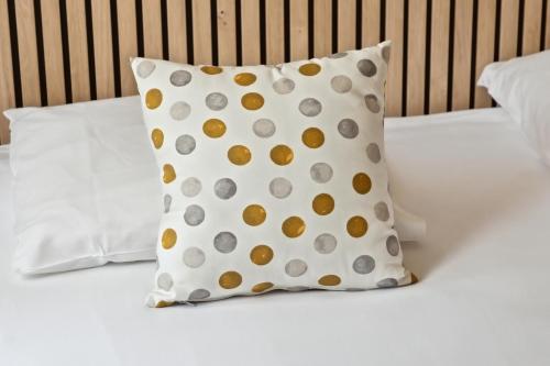 a polka dot pillow on a bed at Hôtel La Nartelle in Sainte-Maxime
