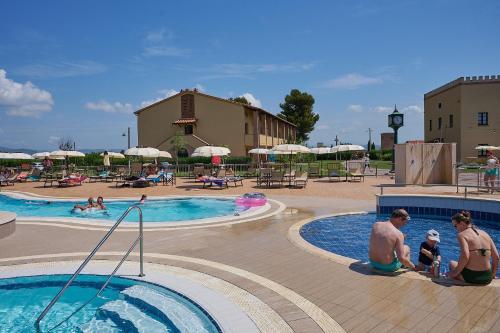 a group of people in a pool at a resort at Salvapiano Holiday Ranch in Riotorto