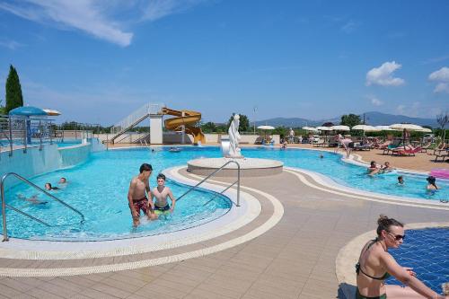 a group of people in a swimming pool at Salvapiano Holiday Ranch in Riotorto