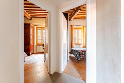 a room with a hallway with a bed and a room with a hallway at Cosimo Charme in Chianti in Barberino di Val dʼElsa