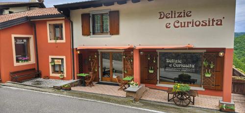 a building with a sign that reads balete and crucuitous at Casa Vacanze La Stele in Castelmonte