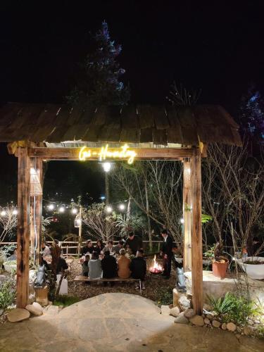 a group of people sitting under a gazebo at night at Gio Homestay & Bungalow Sapa in Sa Pa