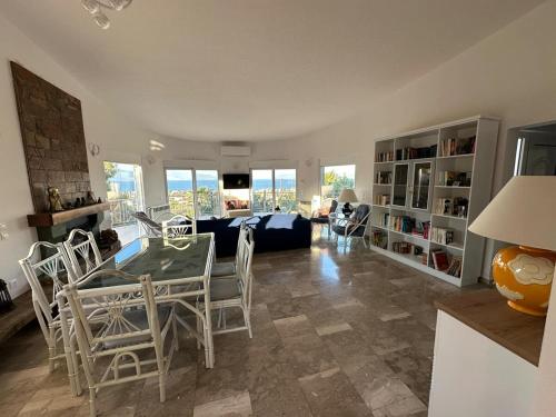 a living room with a table and chairs and a couch at La maison des oliviers in Kiáton