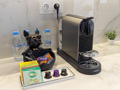 a coffee maker with a mask and glasses next to a microwave at EliteStay by Al Amir in Cabo Negro