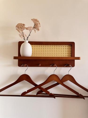a wooden shelf with a vase on a wall at Holi homestay in Houli