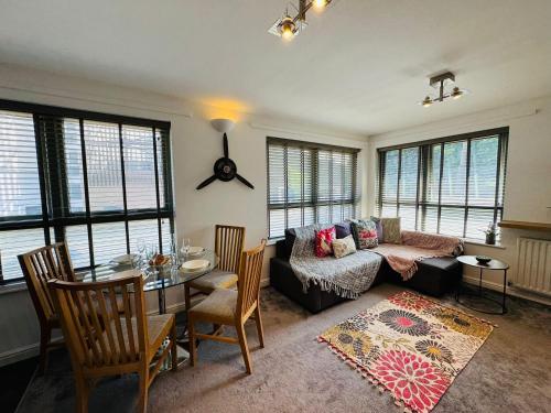a living room with a couch and a table at Fly Hi-Town Centre Apartment in Ifield
