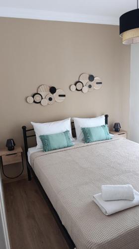 a bedroom with a large bed with two pillows at La Bella casa kavala in Kavala