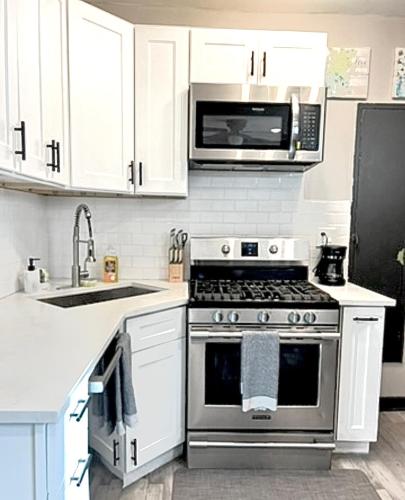 a kitchen with a stove and a microwave at Quiet 1BR, Eat-In Kitchen, Close to Midway in Chicago