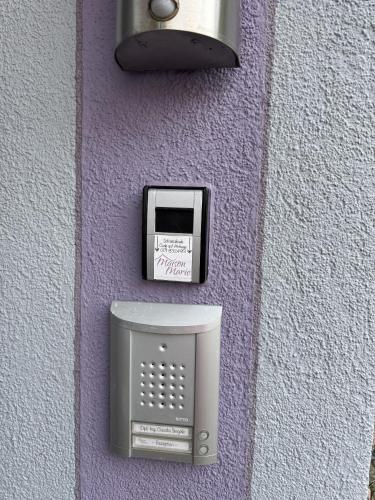 a purple wall with a soap dispenser and a toaster at Maison Marie in Ubstadt-Weiher