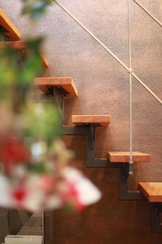 a row of stairs in a room with flowers at Maison Marie in Ubstadt-Weiher