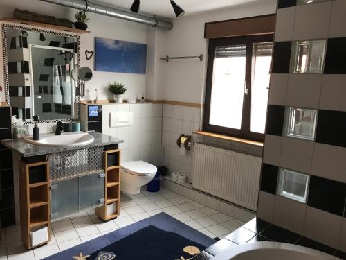 a bathroom with a sink and a toilet at Maison Marie in Ubstadt-Weiher