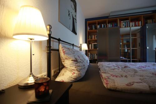 a bedroom with a bed and a lamp on a desk at Maison Marie in Ubstadt-Weiher