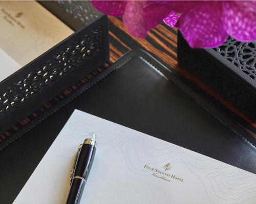 a pen sitting on a paper next to a box at Four Seasons Hotel Casablanca in Casablanca