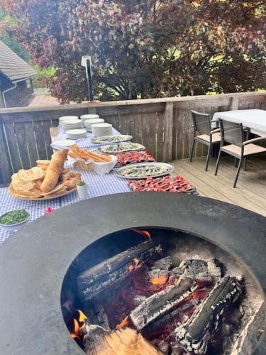 a grill with a table with food on a patio at Seegasthof Breineder - Familien & Seminarhotel in Mönichwald
