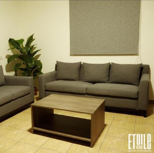 a living room with a couch and a coffee table at Etoile DE Mer in Al ‘Ayn