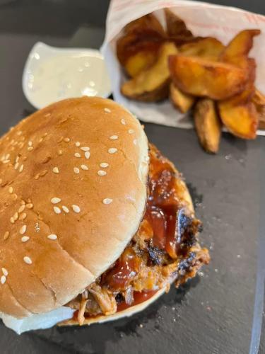 a sandwich and french fries on a table at Seegasthof Breineder - Familien & Seminarhotel in Mönichwald