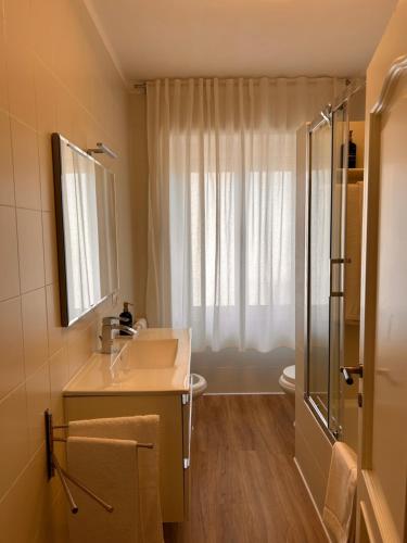 a bathroom with a sink and a shower at Guest House - La bella vita in Orosei