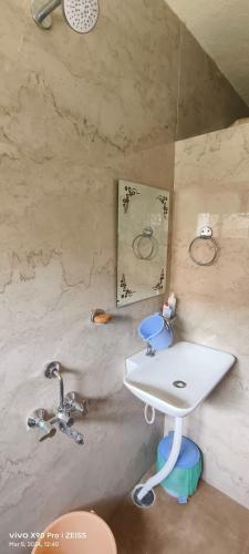 a bathroom with a sink and two faucets at Sukumar Villas in Nellore