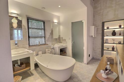 a large bathroom with a large tub and two sinks at LA BASTIDE DES CULS-ROUSSET in Marseille