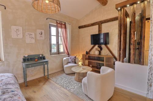 a living room with a couch and a table at LA BASTIDE DES CULS-ROUSSET in Marseille