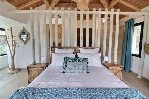 a bedroom with a large bed in a room with wooden ceilings at LA BASTIDE DES CULS-ROUSSET in Marseille