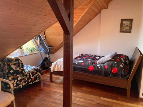 a bedroom with a bed and a chair in a attic at Poddasze Pierwoszyno in Pierwoszyno