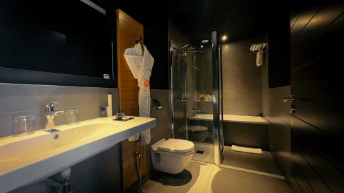a bathroom with a shower and a toilet and a sink at ONOMO Hotel Casablanca City Center in Casablanca