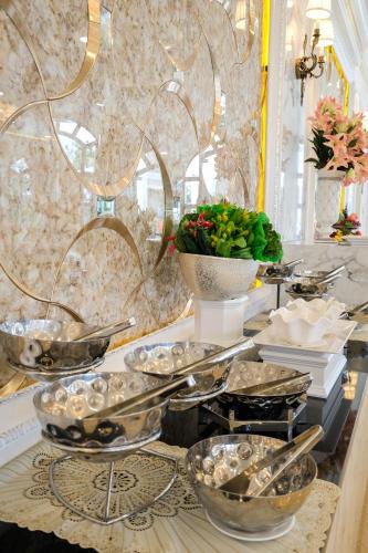 a buffet with a bunch of silver dishes on a table at LK Grand Empire in Pattaya South