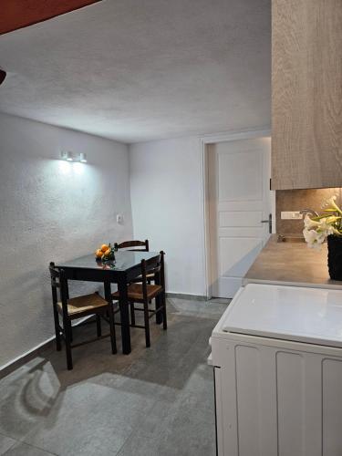 a kitchen with a table and chairs in a room at Porto Castello in Fira